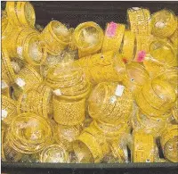  ??  ?? n SELL-OFF: Some of the gold that was smuggled into the UK by Chaudry Ali (right)