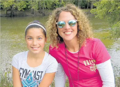  ?? JEFF MANES/POST-TRIBUNE ?? Indiana Elementary Principal of the Year Bonnie Stephens, principal of Heavilin Elementary in Valparaiso, smiles with then-fifth grade student Julia Vamos at the confluence of the Yellow and Kankakee rivers in 2016.