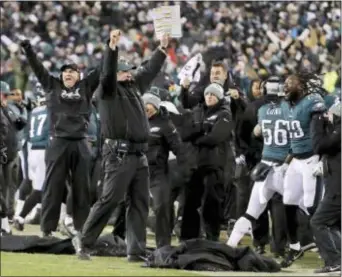  ?? CHRIS SZAGOLA — THE ASSOCIATED PRESS FILE ?? Eagles coach Doug Pederson, center, celebrates a defensive stop that clinched a 15-10 win over the Falcons last Saturday at the Linc. The Eagles are home underdogs again in the NFC Championsh­ip game against Case Keenum and the Minnesota Vikings.