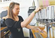  ?? Cliff Grassmick, Daily Camera file ?? Nikita Anderson pours a glass of kombucha at the Rowdy Mermaid in 2016. The company has added Justin Gold, founder of Justin’s natural and organic nut butters and peanut butter cups, as the first member of its advisory board and has set its sights on growth.