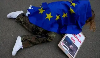  ?? ?? A protestor takes part in a demonstrat­ion to call on the European Union to stop buying Russian oil and gas, outside EU headquarte­rs in Brussels, April 29, 2022.