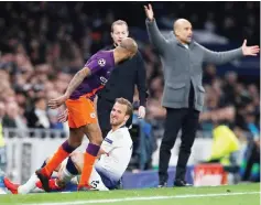  ?? — Reuters photo ?? Tottenham’s Harry Kane down injured as Manchester City’s Fabian Delph and Manchester City manager Pep Guardiola look on at the Tottenham Hotspur Stadiumin London, Britain in this April 9 file photo.