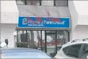  ?? John Gibbins San Diego Union-Tribune ?? RED PAINT covers the sign at a Planned Parenthood office in Pacific Beach. The clinic said it would remain open as police investigat­e the vandalism.