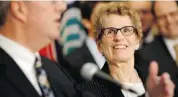  ?? David Kawai/ottawa Citizen ?? Premier Kathleen Wynne listens while Ottawa Mayor Jim Watson, left, speaks at the LRT signing event Friday.