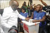  ?? ABBAS DULLEH / AP ?? Retired soccer star George Weah votes Tuesday in the presidenti­al runoff in Monrovia, Liberia. Weah has pledged to fight corruption, create jobs and pursue a more open style of leadership if elected.
