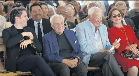  ?? Mel Melcon Los Angeles Times ?? L.A. PHIL Music Director Gustavo Dudamel, from left, architect Frank Gehry and L.A. Phil board member Thomas Beckmen and wife Judith at the unveiling Wednesday of Gehry’s design for the YOLA Center building in Inglewood named after its donors, the Beckmens.