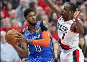  ?? CRAIG MITCHELLDY­ER — THE ASSOCIATED PRESS ?? Thunder forward Paul George, left, looks to pass around Portland ‘s AlFarouq Aminu in Portland, Ore. George officially joined the Thunder on Wednesday.