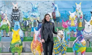  ?? ?? Big fan Environmen­t minister Mairi Mcallan with the“flock to the Show”scupltures including the Doddie Weir tartan sheep by Hamilton artist Megan Reilly