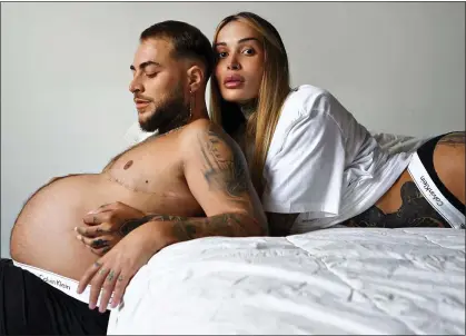  ?? ?? FASHION STATEMENT: Pregnant trans man Roberto Bete with partner, trans woman Erica Feeha, in the Calvin Klein ad