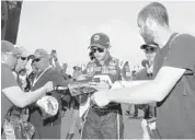  ?? BUTCH DILL/AP ?? NASCAR driver Chase Elliott signs autographs after qualifying first for the NASCAR auto race today at Talladega.