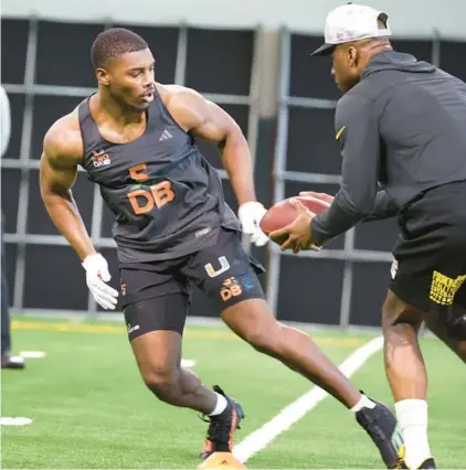  ?? CARLINE JEAN/SOUTH FLORIDA SUN SENTINEL PHOTOS ?? University of Miami safety Kamren Kinchens works out for NFL scouts during the Hurricanes’ Pro Day on Monday in Coral Gables in preparatio­n for the 2024 NFL draft.