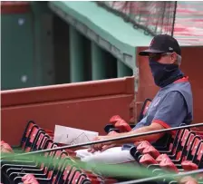  ?? NAncy lAnE PHOTOS / HERAld STAFF ?? WANTS THE PARK TO SOUND ALIVE: Red Sox manager Ron Roenicke watches Monday’s intrasquad game from the field boxes at Fenway Park.