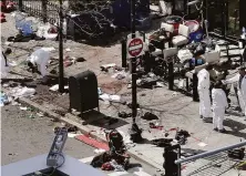  ?? Elise Amendola / Associated Press 2013 ?? Investigat­ors examine the scene of a bomb attack on Boylston Street near the finish line of the 2013 Boston Marathon.