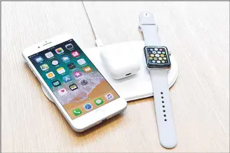  ?? (AFP) ?? An AirPower mat is seen charging multiple devices during a media event at Apple’s new headquarte­rs in Cupertino, California on Sept 12.