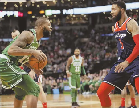  ?? STAFF PHOTOS BY NICOLAUS CZARNECKI ?? FAMILY AFFAIR: Celtics forward Marcus Morris faces off against his brother Markieff, a forward for the Wizards, during yesterday’s game at the Garden.