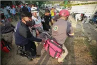  ?? (AP) ?? An injured migrant woman is moved by rescue personnel Thursday from the site of an accident near Tuxtla Gutierrez, Chiapas state, Mexico.