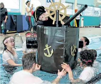  ?? KENNEDY GORDON/EXAMINER ?? Mitchell McColl captains the HMCS Carl Oake pirate ship with help from Team Mitchell during the Rotary Carl Oake Swimathon on Friday morning at the YMCA on Aylmer Street. About 40 teams took part in the annual fundraiser for Rotary and Easter Seals.