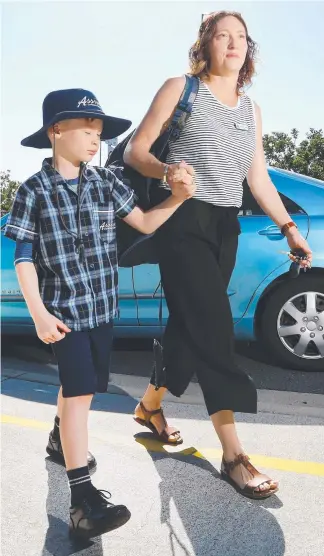  ?? Picture: GLENN HAMPSON ?? Melissa Crowden takes son Tiernan Brennan to school.