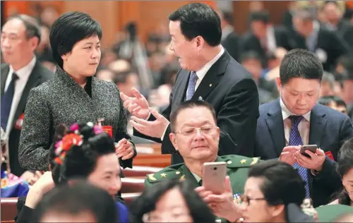  ?? XU JINGXING / CHINA DAILY ?? Deputies talk with each other in the Great Hall of the People in Beijing, before the second plenary meeting of the fifth session of the 12th National People’s Congress, on Wednesday.