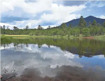  ?? PHOTOS BY MARE CZINAR/SPECIAL FOR THE REPUBLIC ?? The stormy San Francisco Peaks are reflected in Schultz Tank.