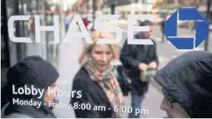  ?? REUTERS ?? A customer walks out of a JPMorgan Chase & Co bank branch in New York.