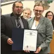  ?? BARBARA ORMSBY - MEDIANEWS GROUP ?? Morton Council President Matio Cimino accepts a resolution of congratula­tions from state Rep. Jennifer O’Mara, D-165 of Springfiel­d, at his final council meeting.