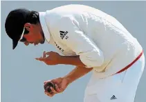  ?? RUI VIEIRA THE ASSOCIATED PRESS FILE PHOTO ?? In this July 30, 2015, photo, England captain Alastair Cook polishes the ball during its Ashes Test cricket match against Australia in Birmingham, England.