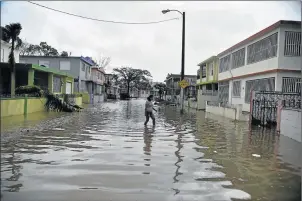  ?? Picture: AFP ?? LIFE-THREATENIN­G: A resident walks through flood water during the passage of neighbourh­ood Puerto Nuevo, in San Juan, Puerto Rico, on Wednesday Hurricane Maria, in the