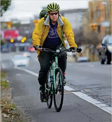  ?? STEPHEN SPILLMAN FOR AMERICAN-STATESMAN PHOTOS ?? Andrew McKenna uses his bike for everything from social events to errands. He says cycling became a passion — 10 years in — after he rode 50 miles at the Hill Country Ride for AIDS, a feat he didn’t think he could accomplish.