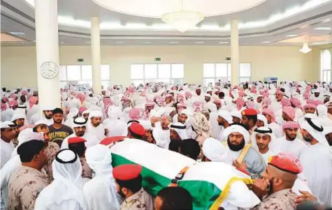  ??  ?? First Corporal Saeed Mattar Ali Al Kaabi’s body being carried into Fujairah’s Al Tawhid mosque for the funeral prayer yesterday. He was buried in Al Quryah cemetery.