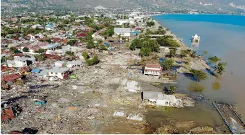  ?? — AFP ?? An aerial view shows the earthquake and tsunami devasted neighbourh­ood in Palu, Indonesia’s Central Sulawesi on Monday.