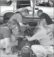  ?? Tammy Weinman ?? At right, Jacklyn Sonnenfeld EMT student, Arnold; Andrew Tickle EMT, Arnold; Chris Walker EMT, Mason City; and Tammy Weinman EMT, Arnold practice packaging a patient during extricatio­n training.