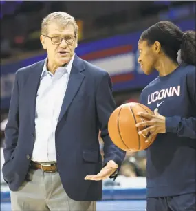  ?? Icon Sportswire / via Getty Images ?? UConn coach Geno Auriemma, left, talks to point guard Crystal Dangerfiel­d during a game against SMU last season.