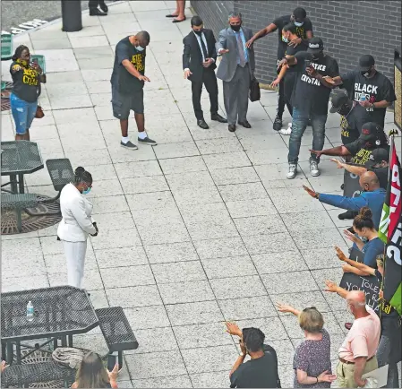  ?? SEAN D. ELLIOT/THE DAY ?? Supporters gather around Crystal Caldwell, center left in white, as they wait outside Friday for the court appearance of Philip Sarner and Emily Orbay in New London Superior Court.