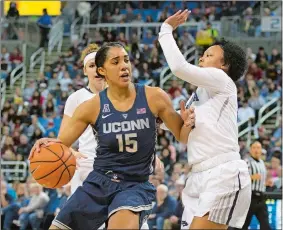  ?? TOM SMEDES/AP PHOTO ?? UConn’s Gabby Williams (15) drives against Nevada’s Camariah King during the topranked Huskies’ 88-57 victory on Tuesday night in Reno. It was a homecoming for the senior All-American, who scored 18 points before a large group of family and friends.