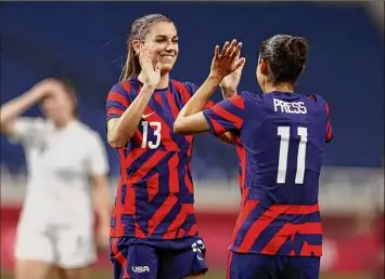  ?? Photos by Francois Nel / Getty Images ?? Alex Morgan (13) of Team USA celebrates with teammate Christen Press after an own goal by Team New Zealand gave the Americans a 6-1 lead at the Tokyo 2020 Olympic Games.