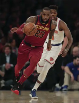  ?? JULIE JACOBSON — THE ASSOCIATED PRESS ?? LeBron James drives down court past Knicks guard Frank Ntilikina during the first quarter April 9 in New York.