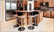  ?? DREAMSTIME ?? Space-saving kitchen islands need the right bar stools.