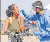  ?? AFP ?? A paramedic with Israel’s national emergency medical service performs a swab test at a facility in Tel Aviv.