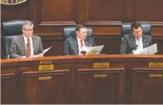  ?? ?? From left, Commission­ers Joe Graham, R-Lookout Valley; Jeff Eversole, R-Ooltewah; and Mike Chauncey, R-East Ridge, look at copies of the map.