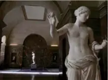  ??  ?? The Venus of Milo sculpture, background, is lit by a ray of light in the Louvre museum.