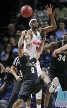  ?? JULIE JACOBSON — THE ASSOCIATED PRESS ?? Syracuse’s Paschal Chukwu (13) blocks a shot by Wake Forest’s Brandon Childress (0) in the ACC men’s tournament Tuesday in New York. Syracuse won, 73-64.