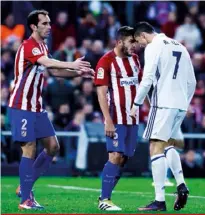  ??  ?? Atlético midfielder Koke reportedly called Ronaldo a “faggot” during a La Liga match in November. Koke’s teammate Diego Godín (left) tried to intervene.