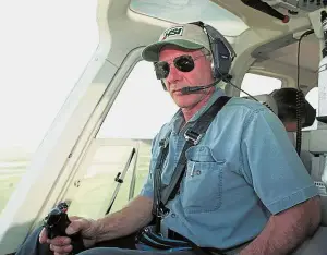  ?? — AFP ?? Skilled
aviator: A file photo showing Ford flying his helicopter on July 10, 2001, near Jackson, Wyoming.