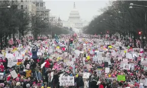  ?? MARIO TAMA / GETTY IMAGES ?? Protesters walk during the Women’s March on Washington, D.C., Saturday. The march in the U.S. capital was a message to misogynist demagogues everywhere, writes Kate Heartfield, that we aren’t going back to the bad old days.