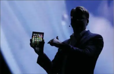  ?? ERIC RISBERG — THE ASSOCIATED PRESS ?? Justin Denison, SVP of Mobile Product Developmen­t, shows off the Infinity Flex Display of a folding smartphone during the keynote address of the Samsung Developer Conference Wednesday in San Francisco.