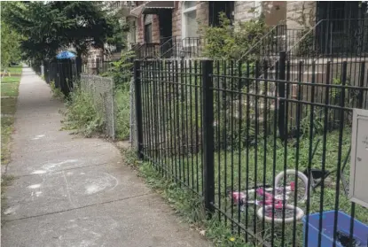  ?? PAT NABONG/SUN-TIMES ?? A bicycle lies on the front yard of a house on the 3200 block of West Fulton Boulevard in East Garfield Park on Saturday. Serenity Arrington, 5, was allegedly stabbed to death there by her mother earlier that day.