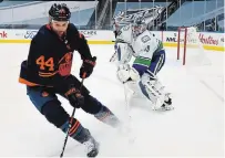  ?? DALE MACMILLAN THE CANADIAN PRESS FILE PHOTO ?? Ex-Pete Zack Kassian of the Oilers snags the puck as Vancouver goalie Braden Holtby tries to clear it in NHL action Jan. 13.