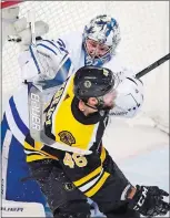  ?? CHARLES KRUPA/ AP PHOTO ?? Toronto Maple Leafs goaltender Frederik Andersen, rear, hits Boston Bruins center David Krejci (46) with his stick during the second period Wednesday in Boston.
