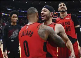  ?? JOHN LEYBA - THE ASSOCIATED PRESS ?? From front, Portland Trail Blazers guard Damian Lillard celebrates with guard Seth Curry and center Enes Kanter after the second half of Game 7 of an NBA basketball secondroun­d playoff series Sunday, May 12, 2019, in Denver. The Trail Blazers won 100-96.